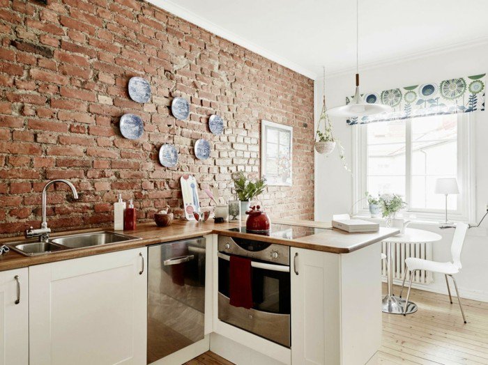 Interior of a kitchen in a house with brick walls