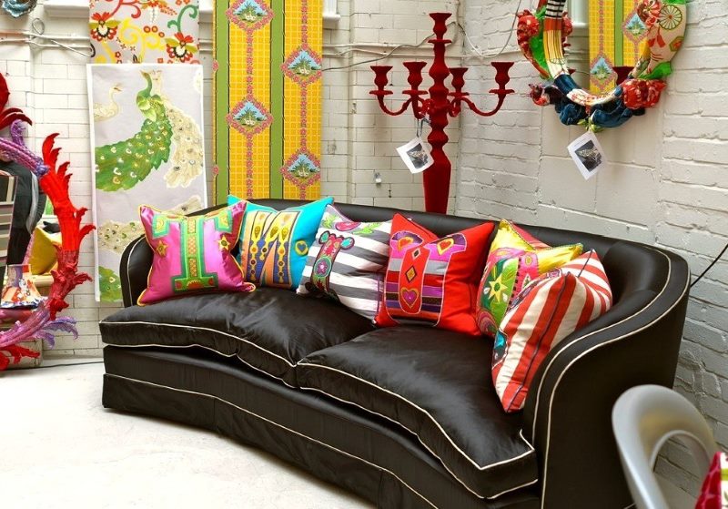 Bright pillows screaming colors on a dark brown sofa
