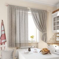 Gray curtains with white print on the kitchen window