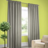 Gray curtains on a light green wall