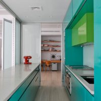 Elongated kitchen with turquoise facades