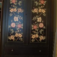 Black wardrobe with a vibrant floral pattern