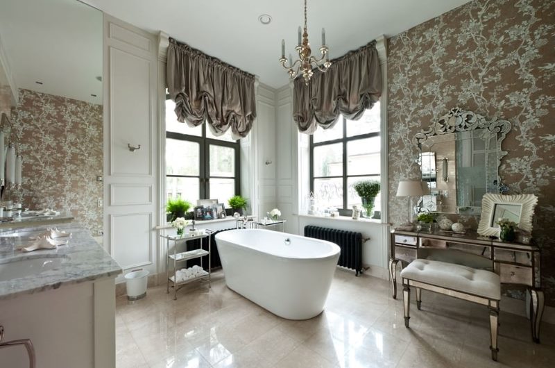 White bath in a room with gray curtains