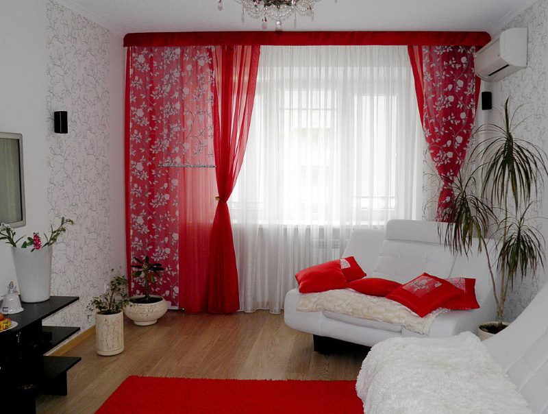 Red curtains in the living room with white furniture