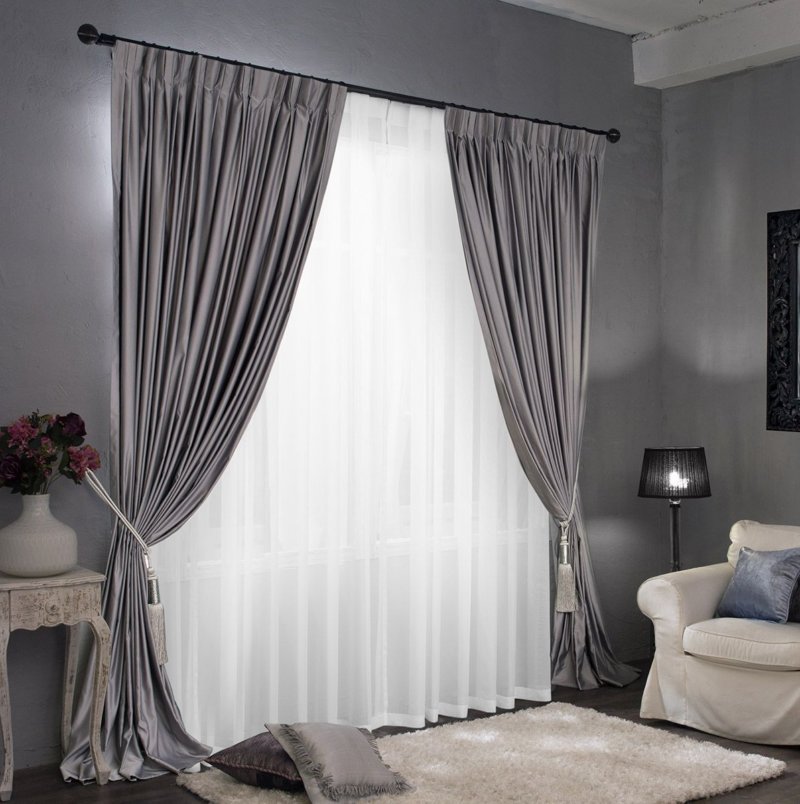 Light gray curtains on the window of the living room of a private house
