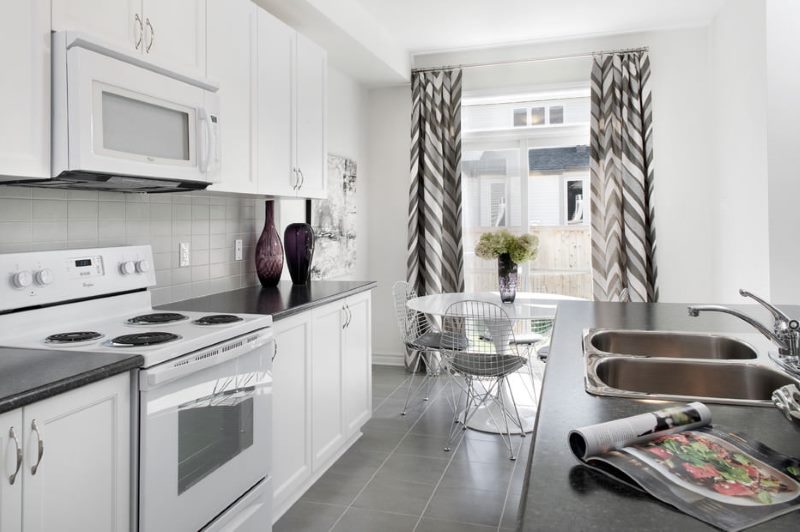 Modern style kitchen interior with gray curtains.