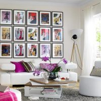 Collection of paintings over a white sofa